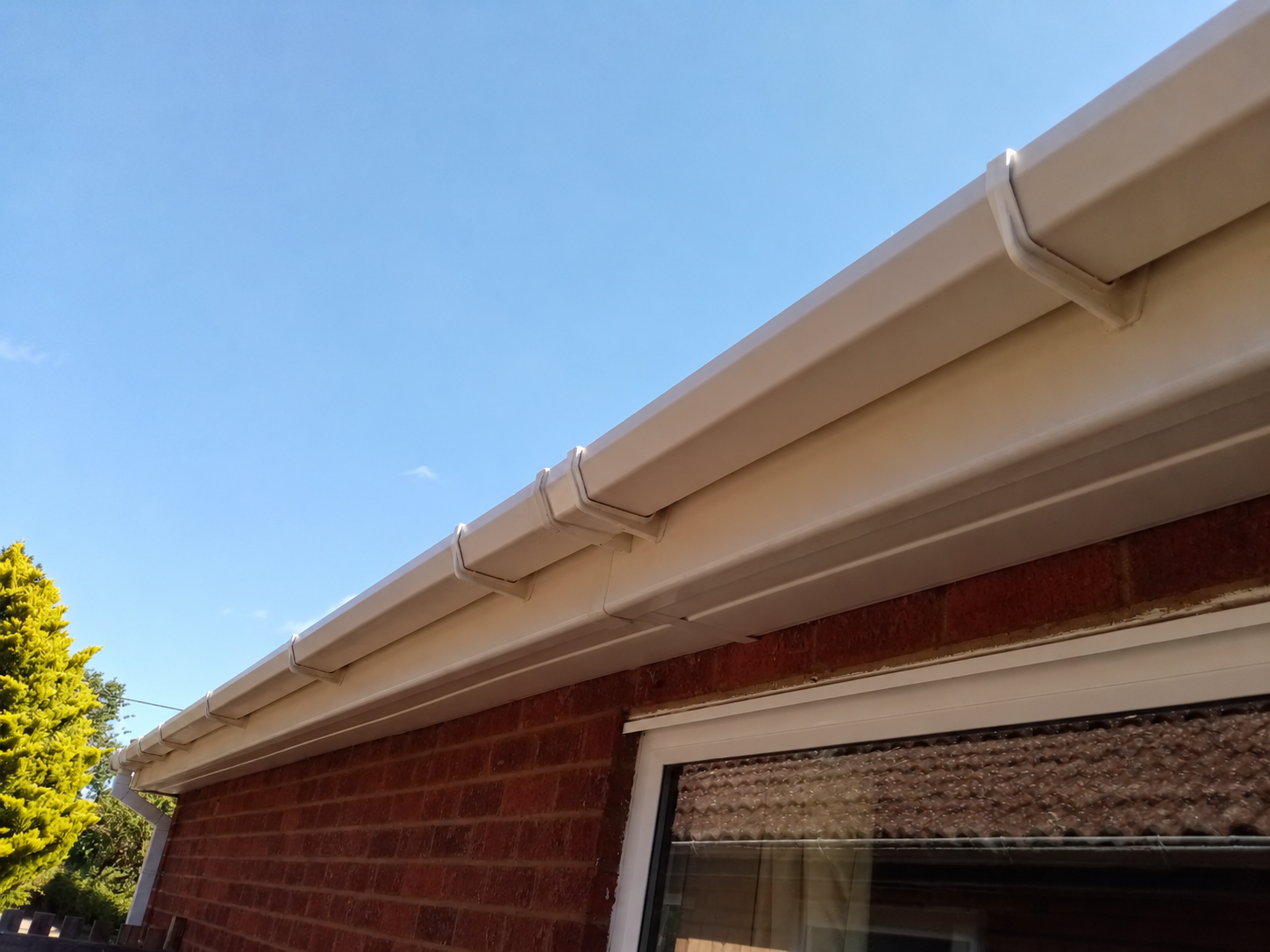After: cleaned gutter, fascia and soffit; photo angle adjusted with AI